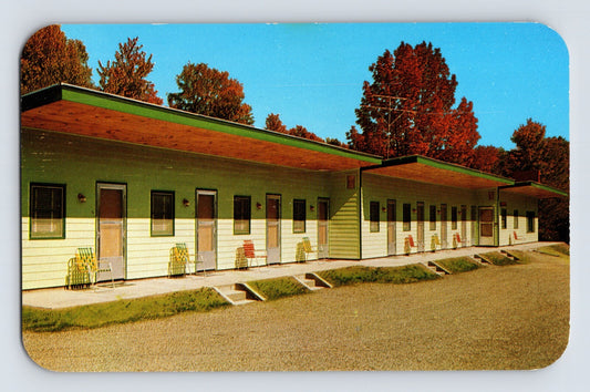 1960s chrome postcard showing the Molly Stark Motel in Brattleboro, Vermont, with long roadside motel wings, colorful doors, and autumn foliage in the background.