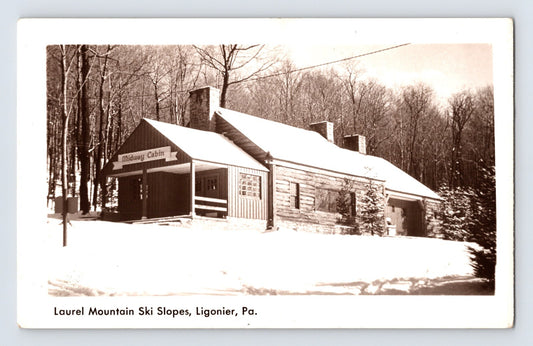 Real photo postcard of Laurel Mountain Ski Slopes in Ligonier Pennsylvania showing snow covered lodge building 1940s