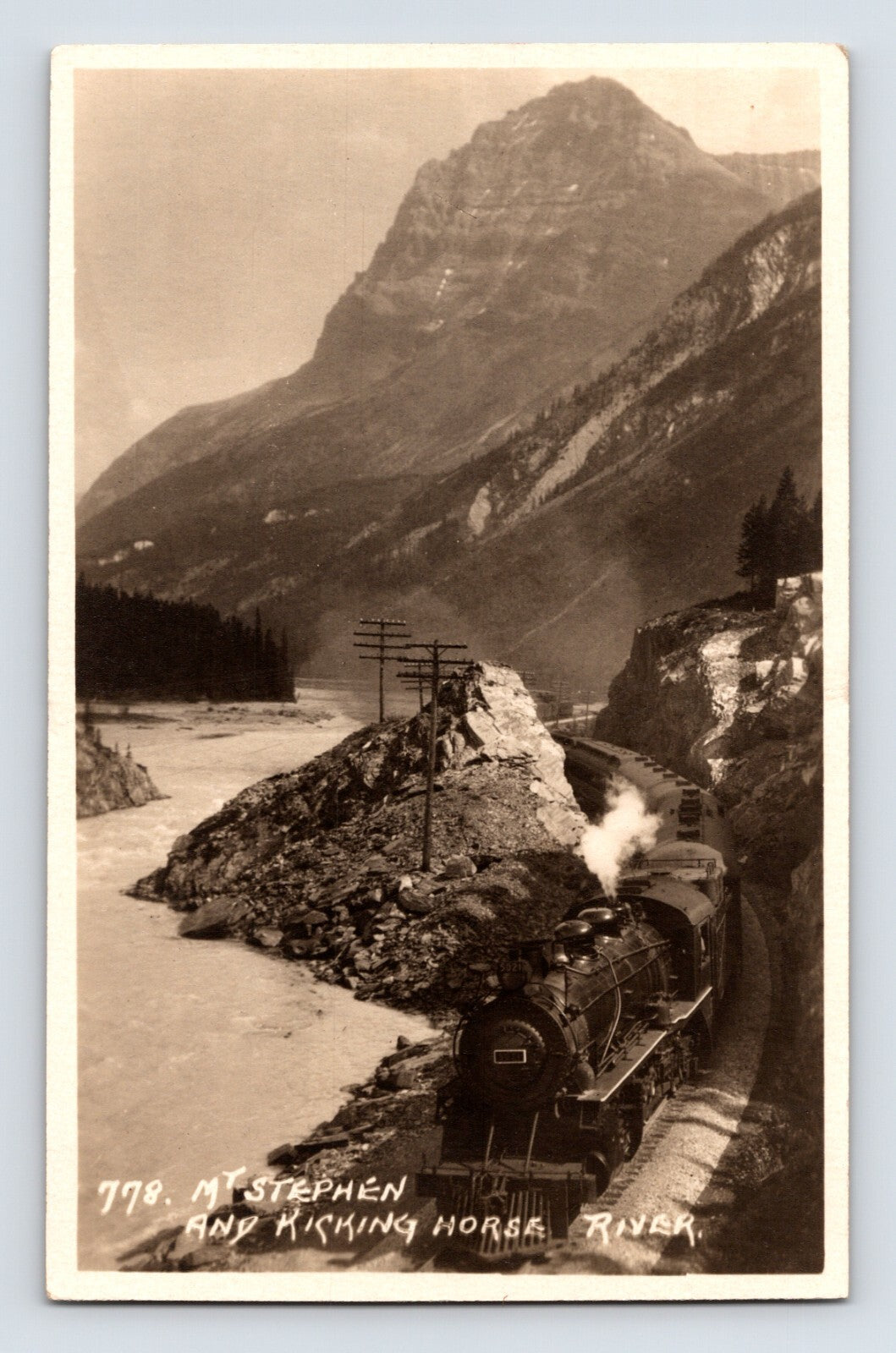 Kicking Horse Pass British Columbia railroad train Mt Stephen 1940 photo postcard with steam locomotive in mountain canyon