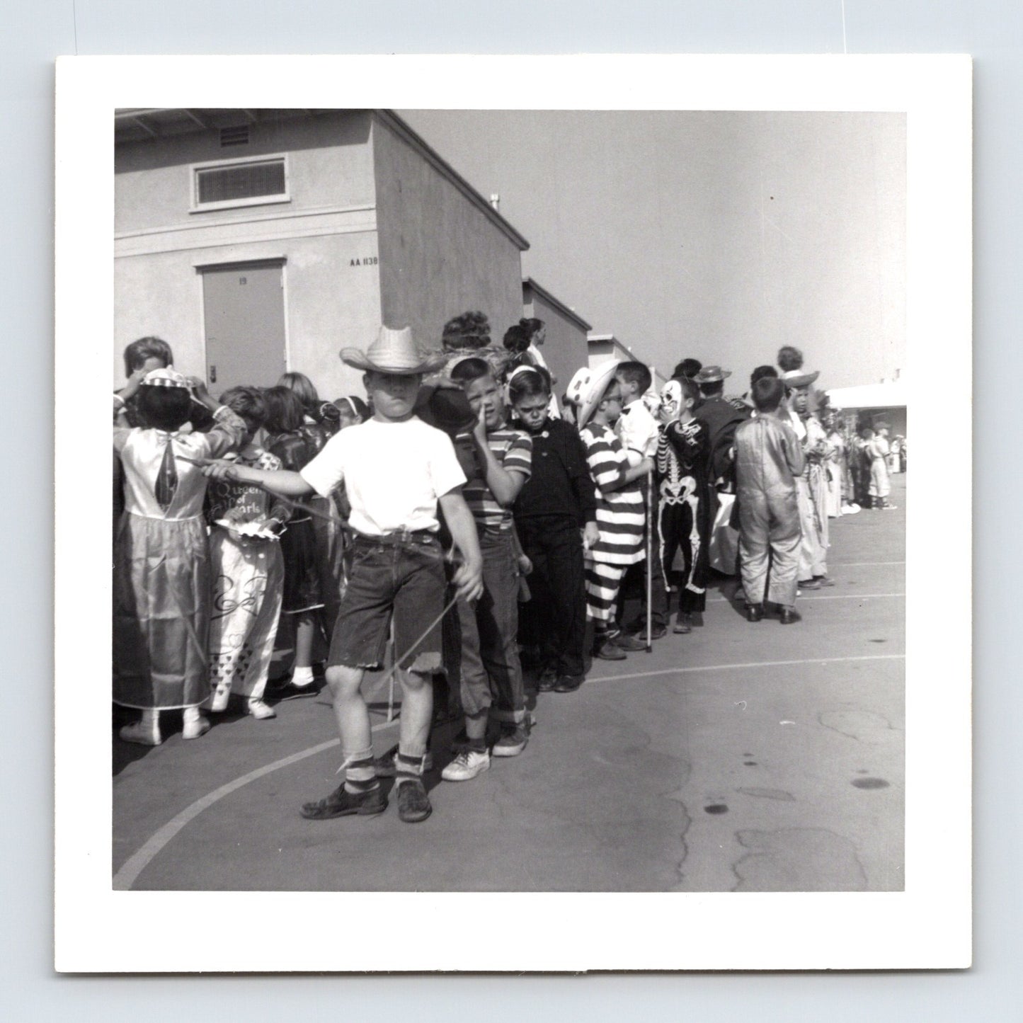 Halloween school parade children line costumes skeleton clown cowboy striped outfit 1950s playground photo 3.5 x 3.5