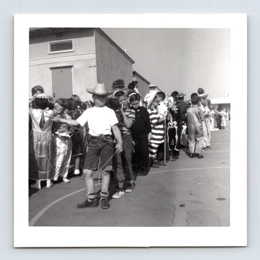 Halloween school parade children line costumes skeleton clown cowboy striped outfit 1950s playground photo 3.5 x 3.5