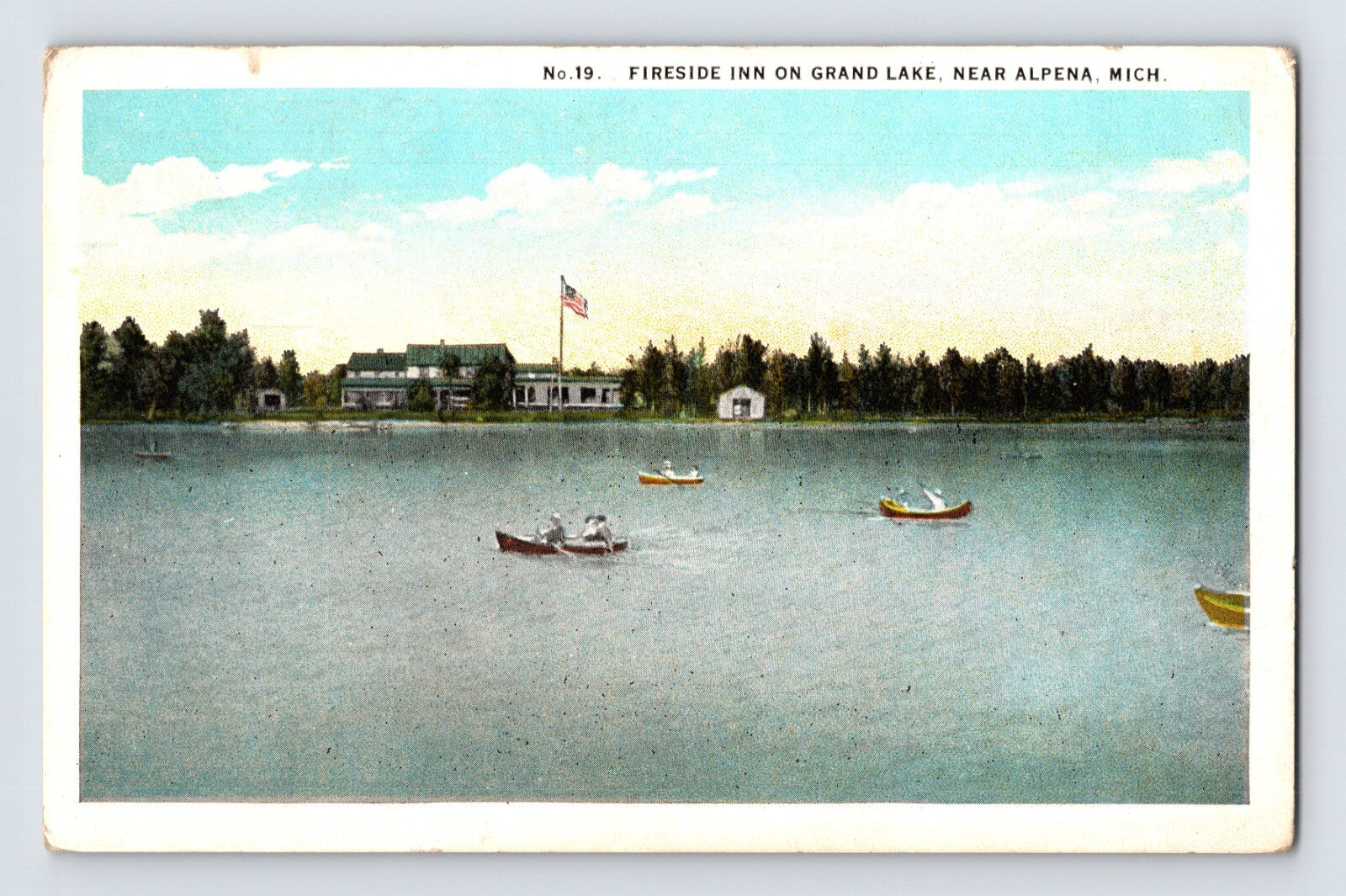 1930s Alpena Michigan Fireside Inn on Grand Lake postcard showing lakeside resort buildings with boats on calm water