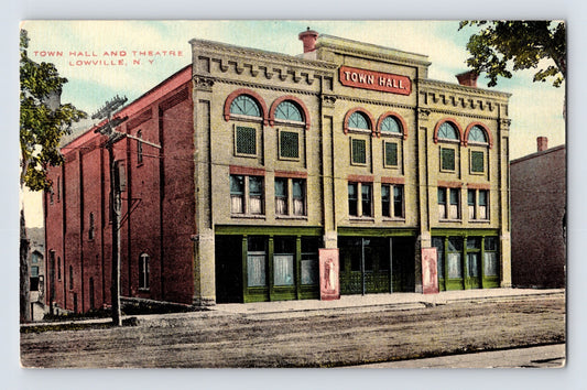 1910s postcard of Town Hall and Theatre in Lowville New York showing ornate two-story civic building with arched windows and streetfront facade