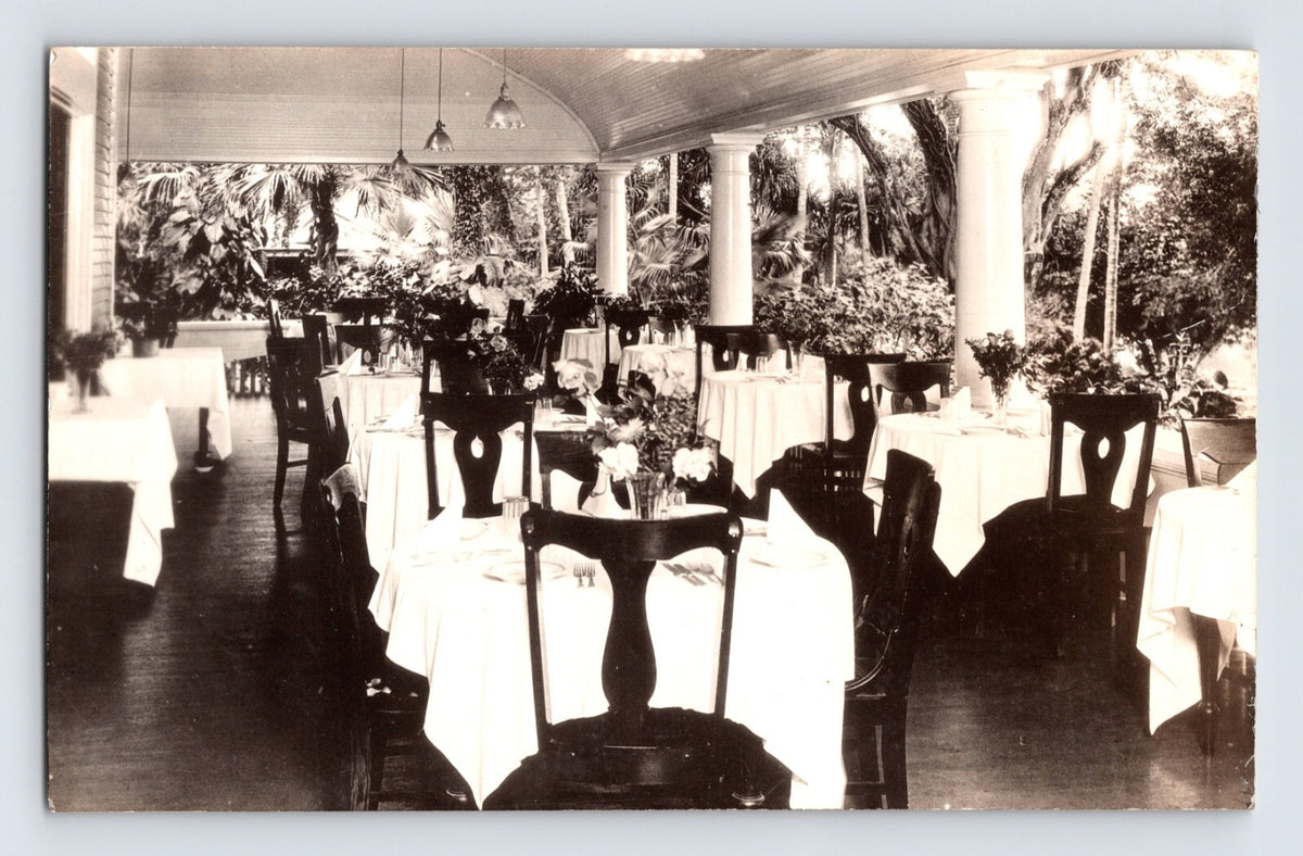 Sepia interior view of hotel dining room patio with white tablecloths and columns in Haleiwa Hawaii 1920s RPPC