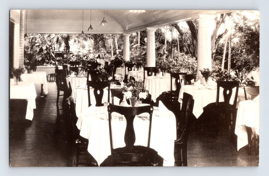 Sepia interior view of hotel dining room patio with white tablecloths and columns in Haleiwa Hawaii 1920s RPPC