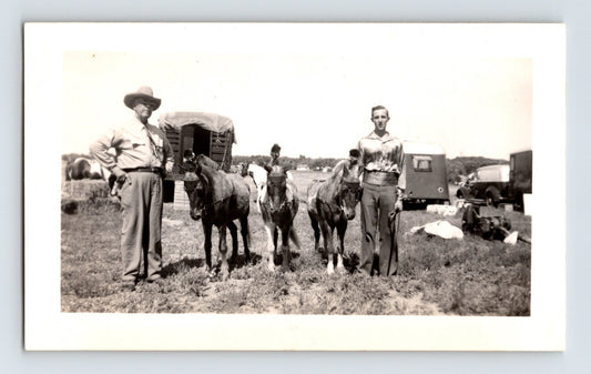 Bell Brothers Circus burros and handlers standing in field with wagons and trailers 1946 circus photo