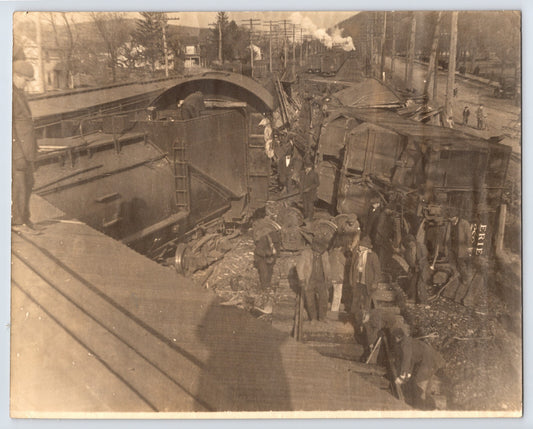 Antique photo showing Erie Railroad train wreck in Suffern New York with overturned cars and workers 1910s