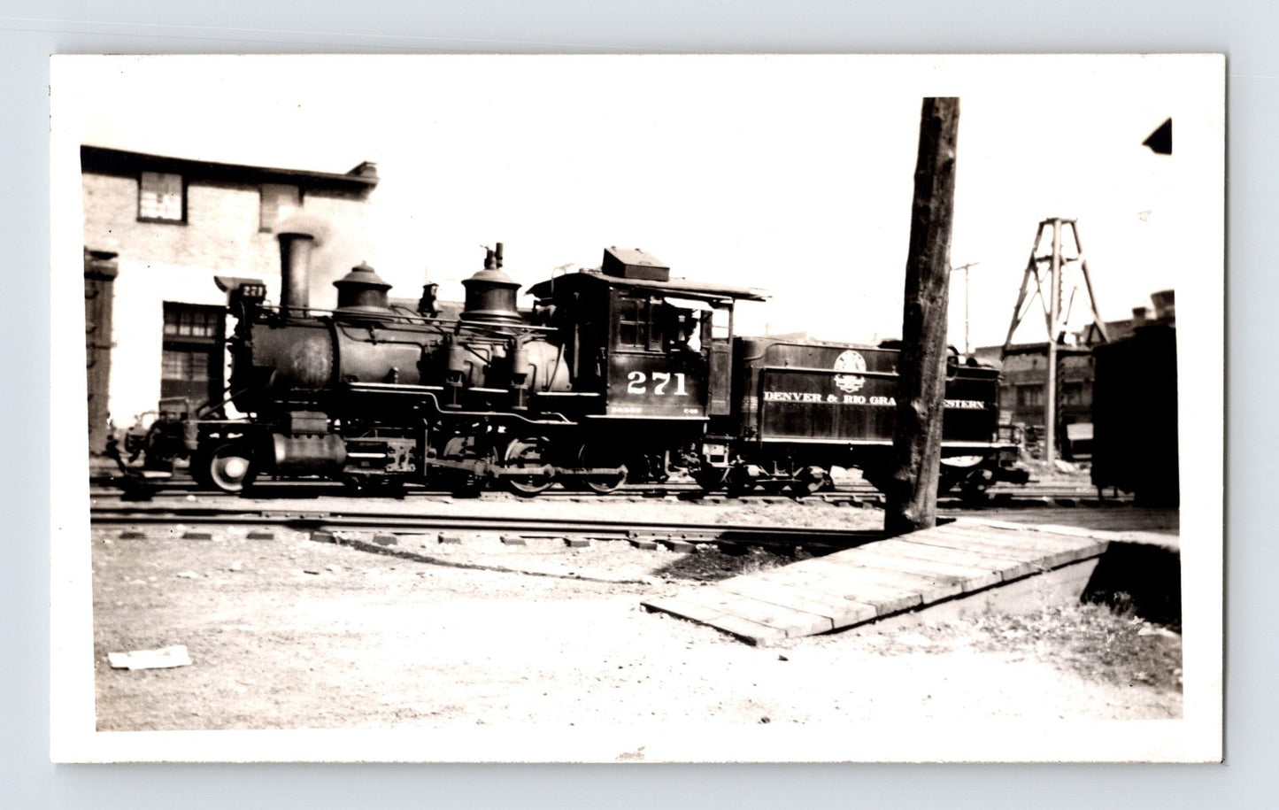 Denver Rio Grande narrow gauge 2-8-0 steam locomotive number 271 switching yard scene 1940s black and white photograph