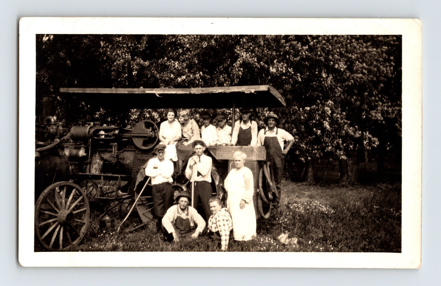 farm family group posing with early tractor agricultural machine rural scene 1940s photo