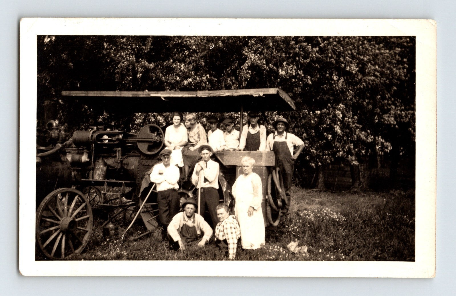 farm family group posing with early tractor agricultural machine rural scene 1940s photo
