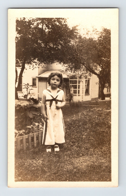 little girl sailor outfit standing in yard near house trees vintage snapshot 1930s