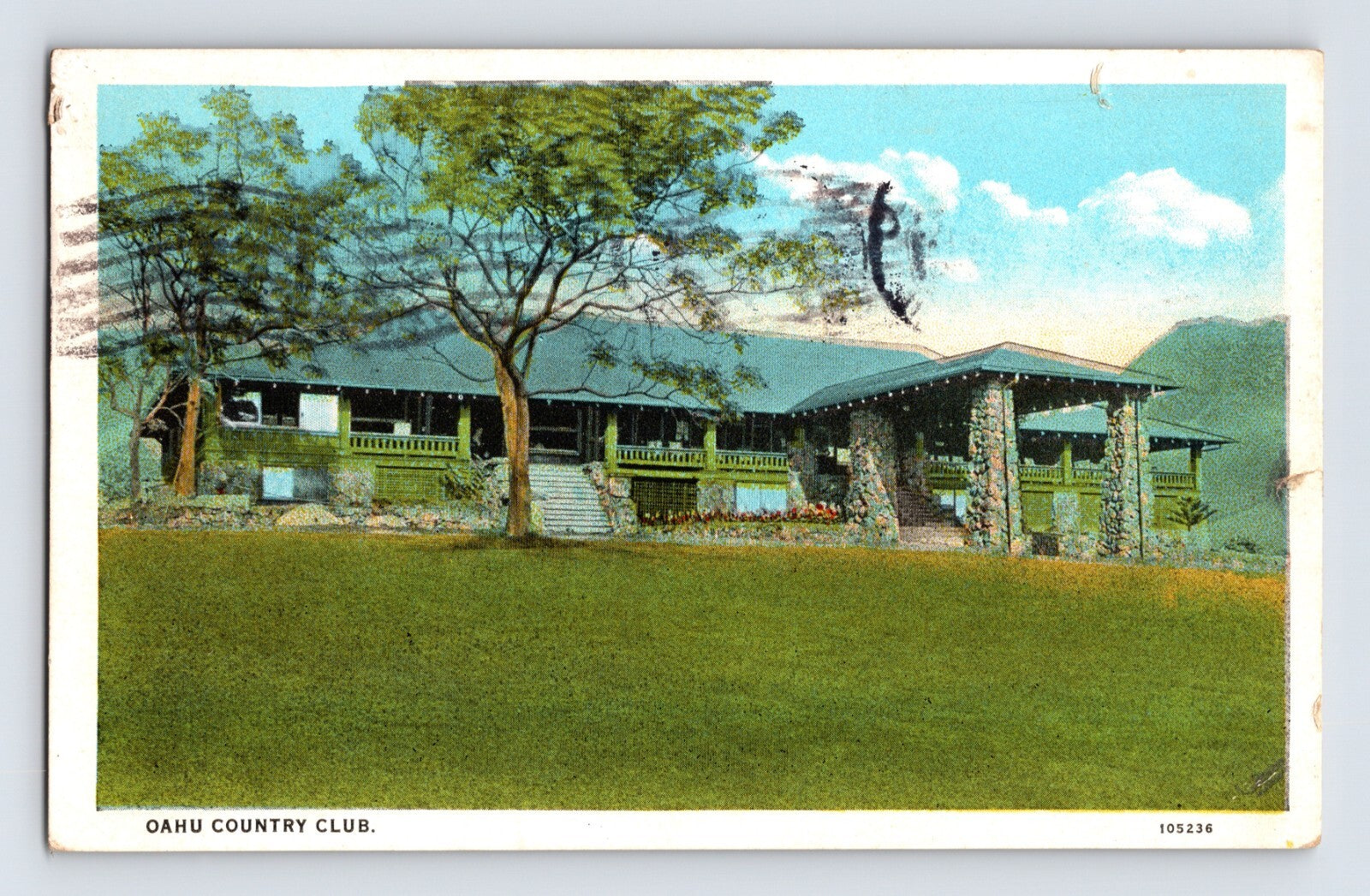 Oahu Country Club clubhouse in Honolulu Hawaii showing stone portico, broad lawn, and mountain backdrop in hand-colored white border postcard