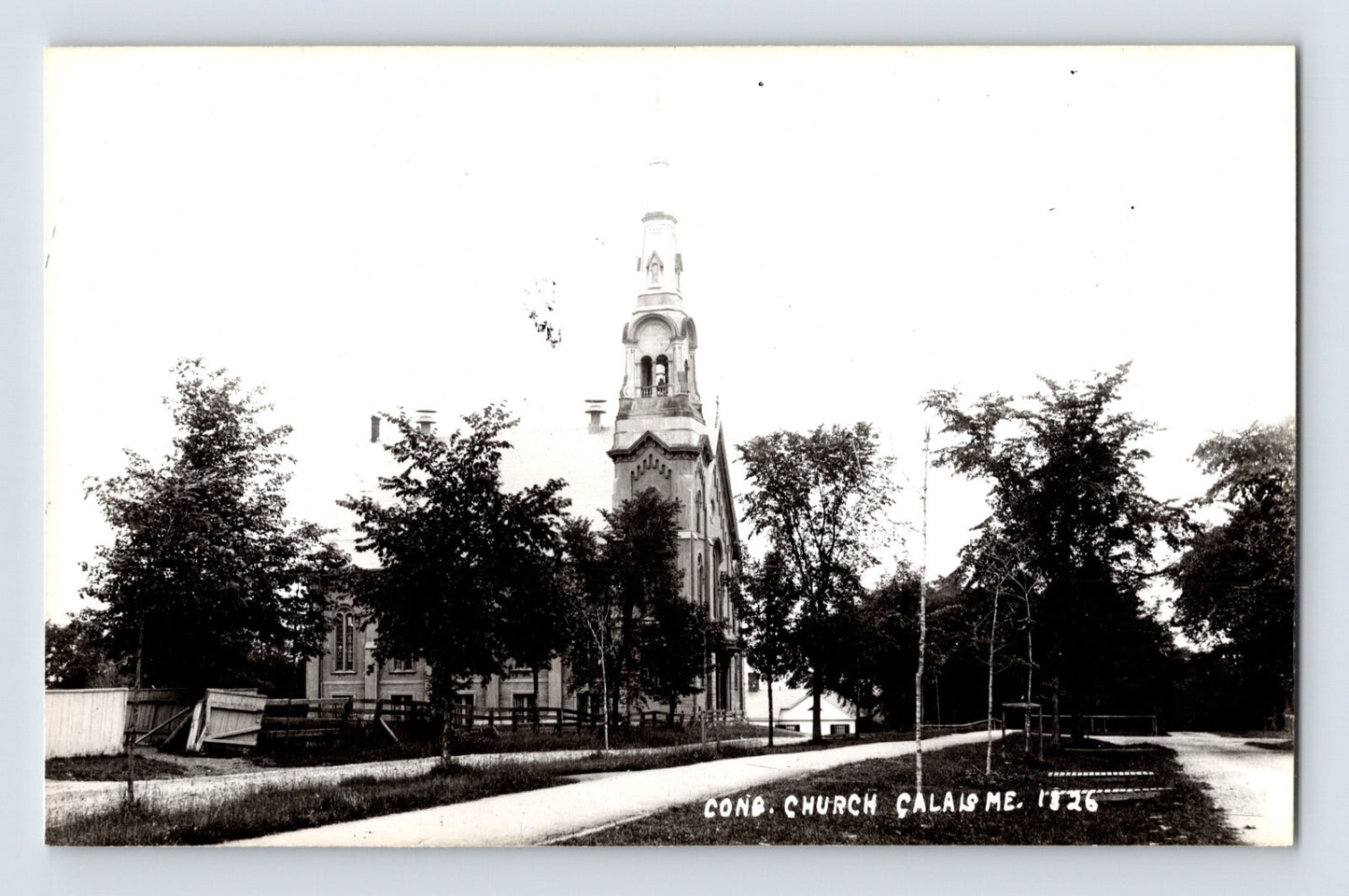 Calais Maine Congregational Church RPPC with tall steeple tree lined street black and white 1950s postcard