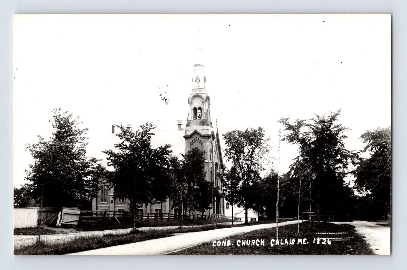 Calais Maine Congregational Church RPPC with tall steeple tree lined street black and white 1950s postcard