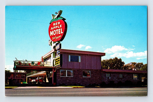 Yakima Washington Red Apple Motel with large apple shaped roadside sign and mid century motor lodge buildings 1960s postcard