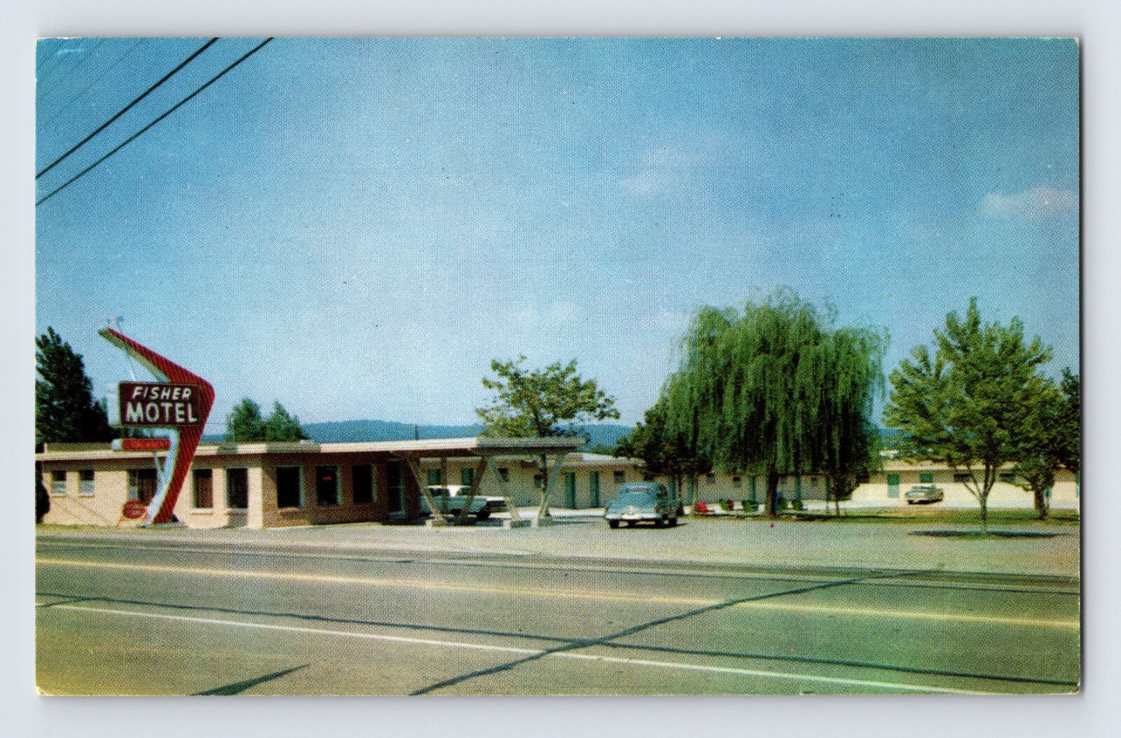 Color chrome postcard view of Fisher’s Motel in Fort Smith, Arkansas, showing a low-rise roadside motor court with mid-century neon-style signage and parked automobiles.