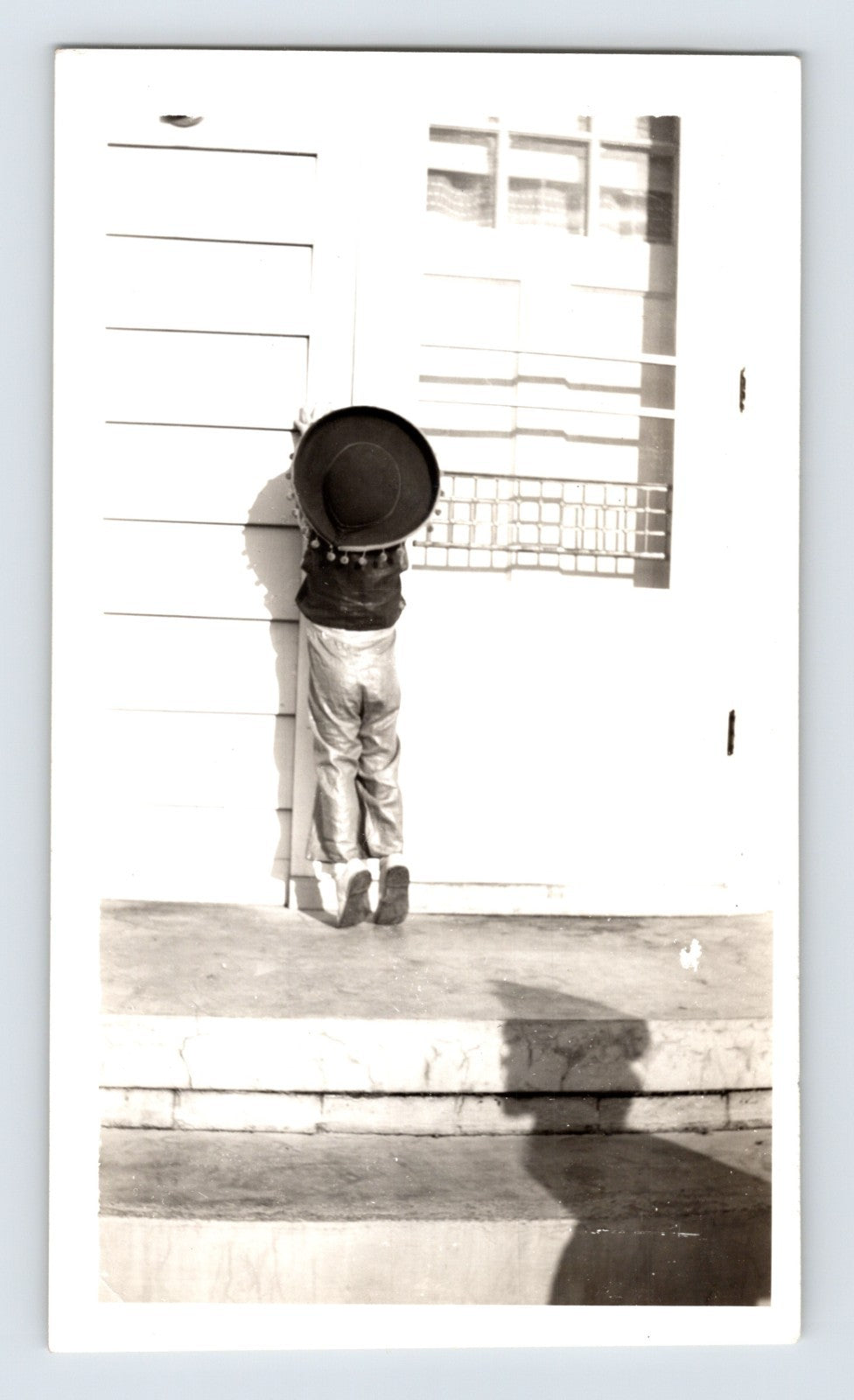 Halloween child costume hat doorstep trick or treat knocking door 1950s photo
