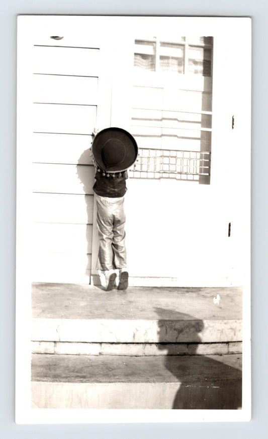 Halloween child costume hat doorstep trick or treat knocking door 1950s photo