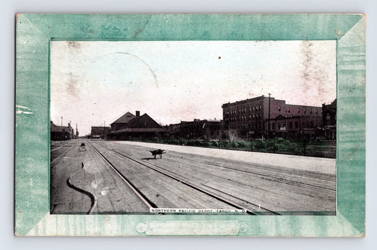 Fargo North Dakota Northern Pacific Depot 1908 postcard with wooden street tracks and commercial blocks
