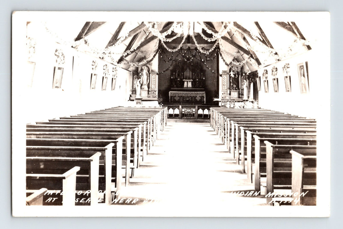 1940s real photo postcard showing the interior of St. Francis Indian Mission near Stone Lake, Wisconsin, with long wooden pews, altar decorations, and vaulted timber ceiling construction.