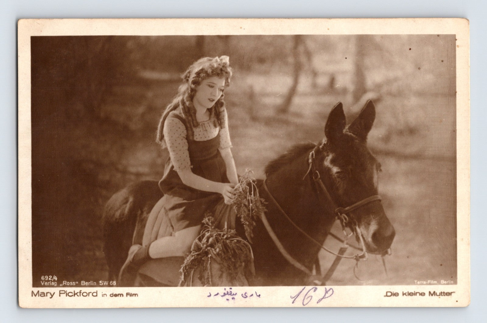 Mary Pickford seated on mule in Die kleine Mutter Ross Verlag 1930s RPPC postcard