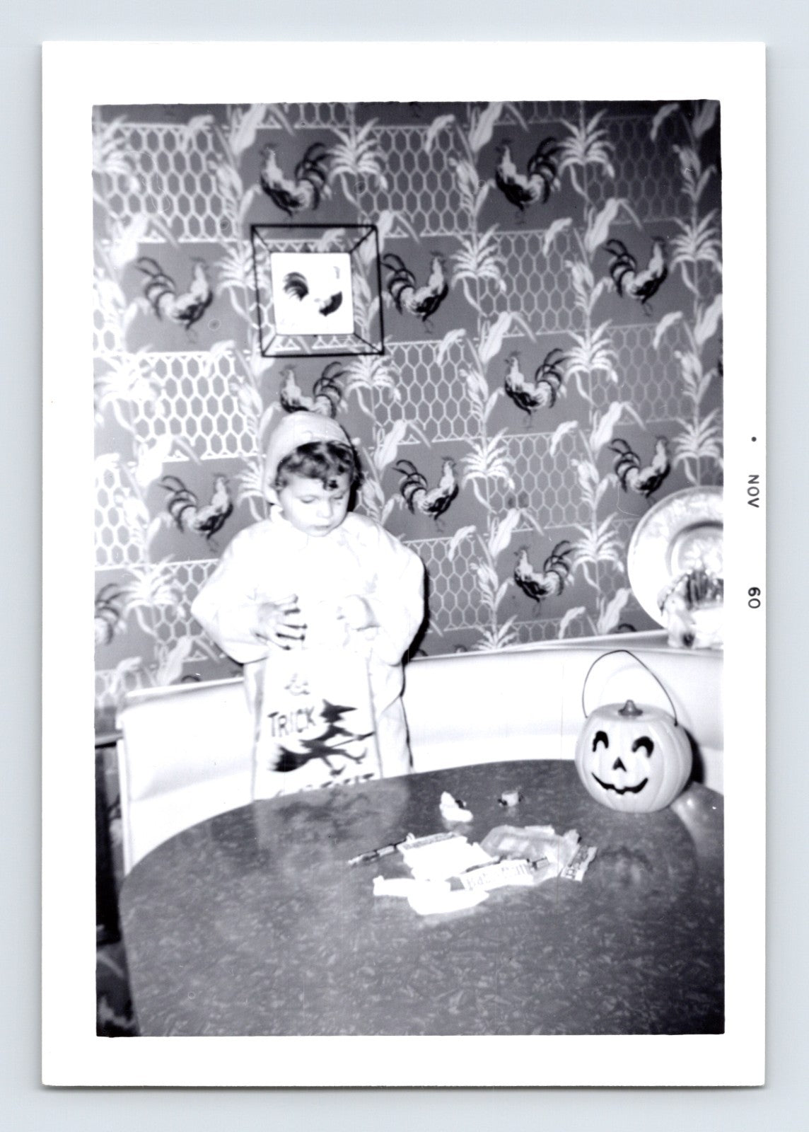 Halloween photo child trick or treat candy table pumpkin bucket indoor 1960 snapshot jack o lantern bowl kitchen scene 5 x 3.5