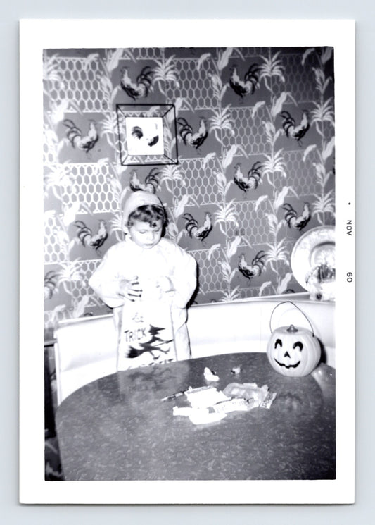 Halloween photo child trick or treat candy table pumpkin bucket indoor 1960 snapshot jack o lantern bowl kitchen scene 5 x 3.5