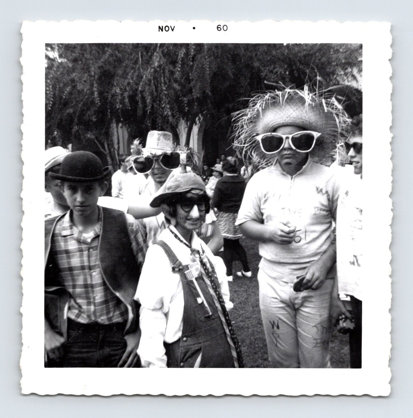 Vintage Halloween party boys costumes oversized sunglasses hats November 1960 outdoor snapshot black white photo