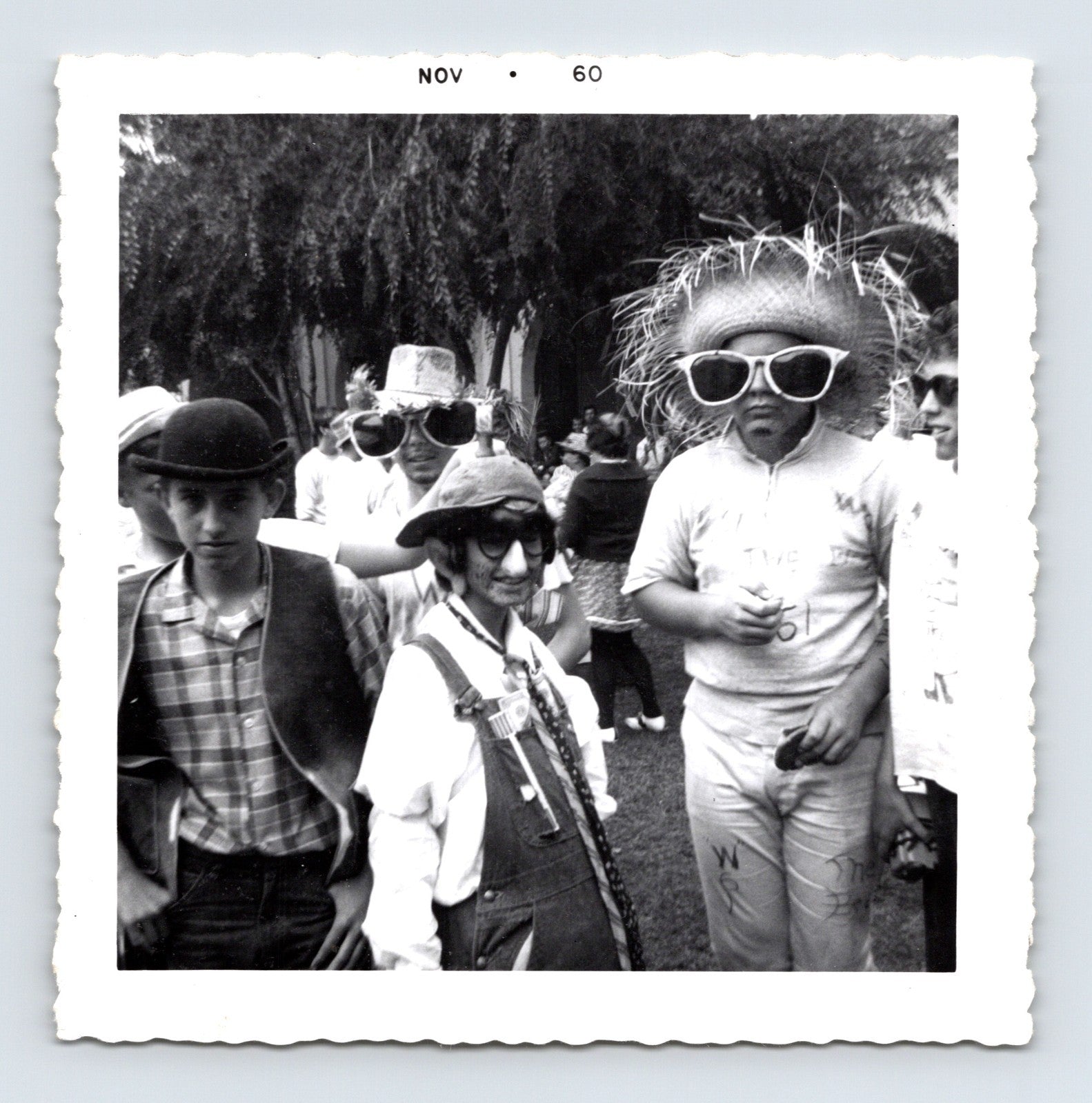 Vintage Halloween party boys costumes oversized sunglasses hats November 1960 outdoor snapshot black white photo