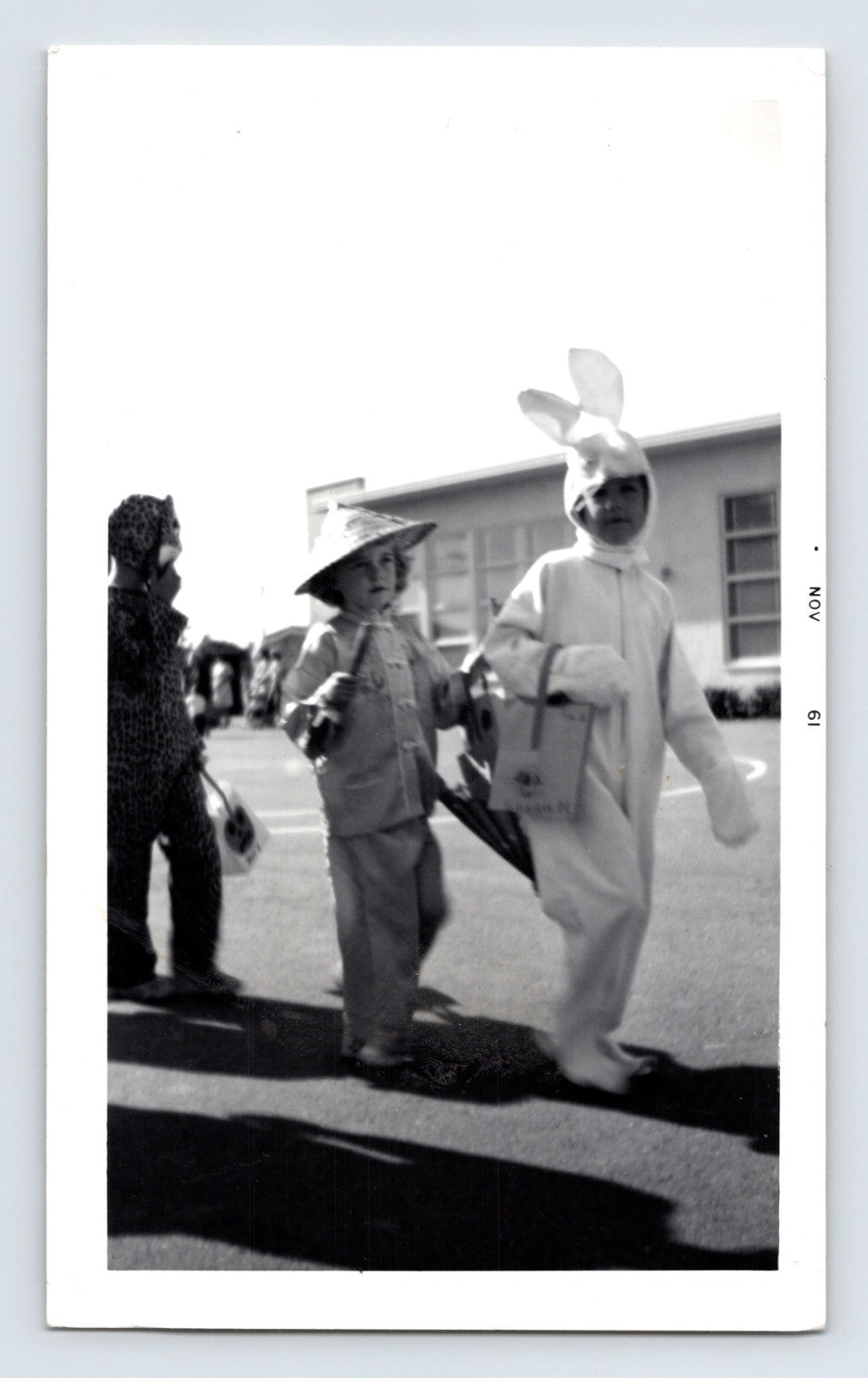 Halloween children costumes bunny suit straw hat leopard costume trick or treat bags 1960s snapshot