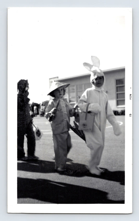 Halloween children costumes bunny suit straw hat leopard costume trick or treat bags 1960s snapshot