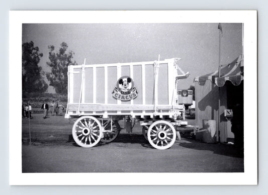 Disneyland Mickey Mouse Club Circus wagon with Mickey Mouse Club Circus sign in foreground and O J Keller wagon visible in background circus grounds 1956 photograph