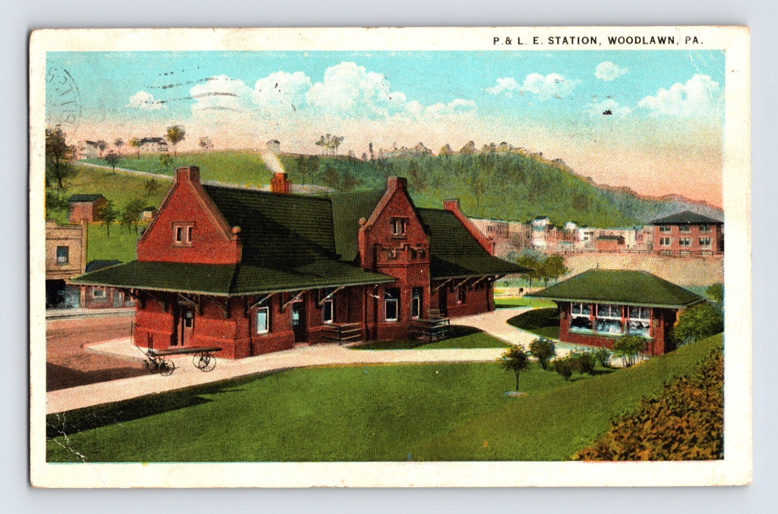 Woodlawn Pennsylvania P and LE railroad station 1925 postcard with red brick depot and landscaped grounds