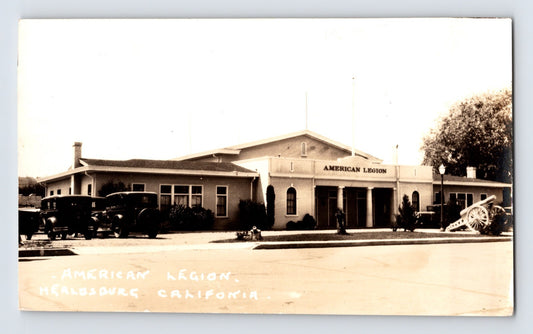 with period automobiles and a field cannon displayed outside.