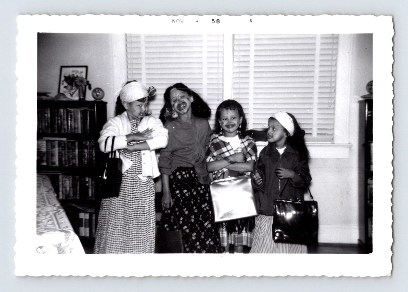 Girls Halloween costume lipstick smiles handbags living room November 1958 photo