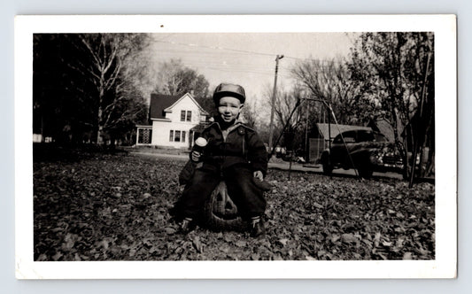boy sitting on jack o lantern pumpkin yard autumn leaves 1949 Halloween photo