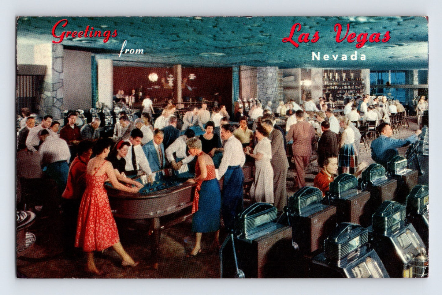 Las Vegas Nevada Flamingo Hotel casino interior 1950s postcard with crowded gaming tables and slot machines