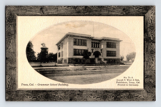 Postcard front shows oval vignette of Tracy California Grammar School building with decorative printed frame border 1910s divided back unposted
