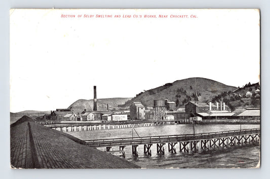 Crockett California Selby Smelting and Lead Company works postcard showing industrial waterfront buildings, smokestacks, piers, and refinery structures along the shoreline.