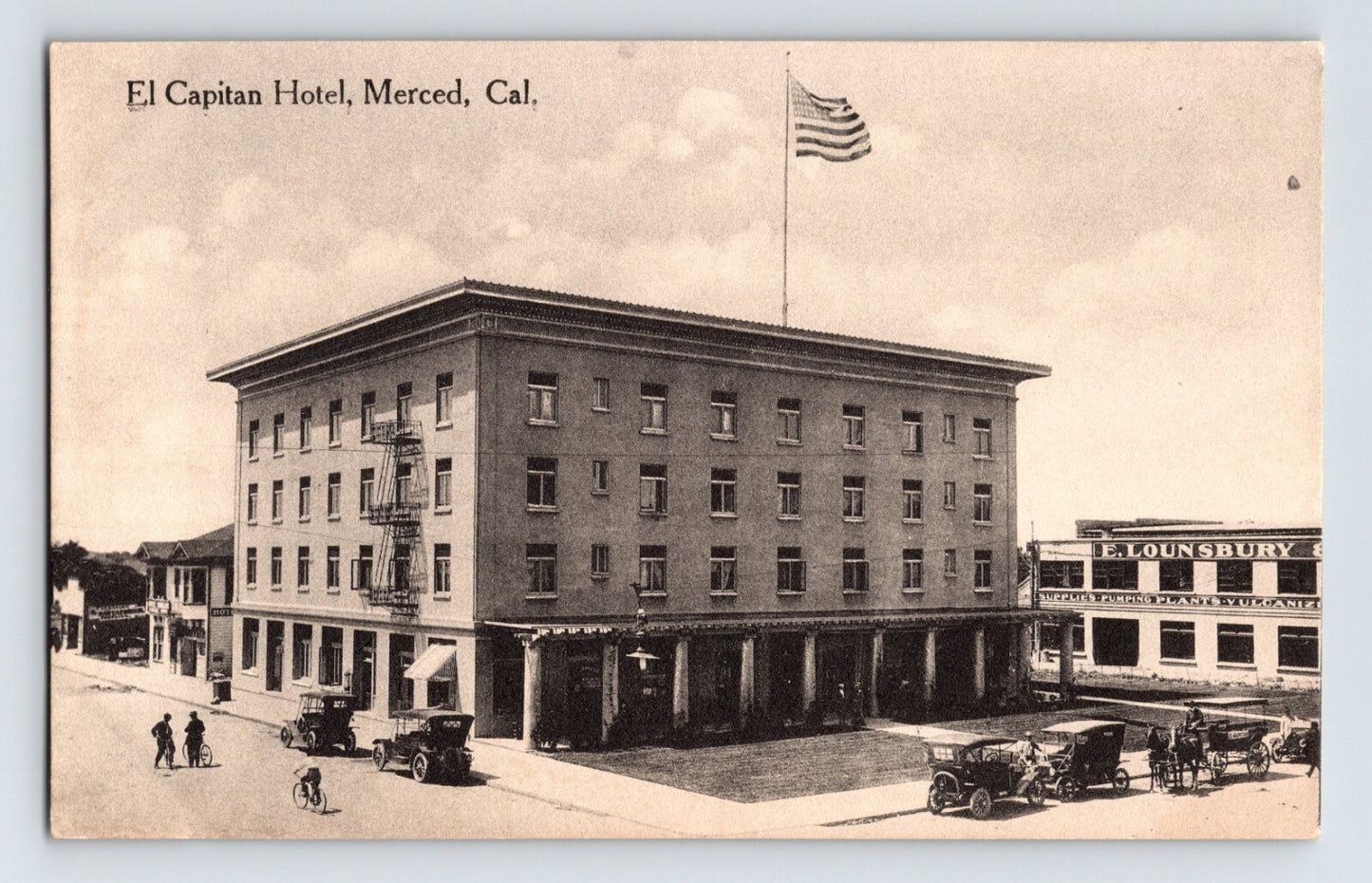 Merced California El Capitan Hotel four story brick building with early automobiles and street scene 1910s postcard