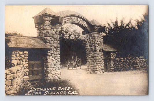 Aetna Springs California stone entrance gate real photo postcard with early automobile entering Napa County resort grounds.