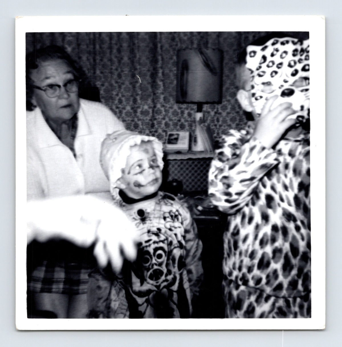 Child Halloween costumes clown and leopard with older woman indoors 1960s snapshot photo