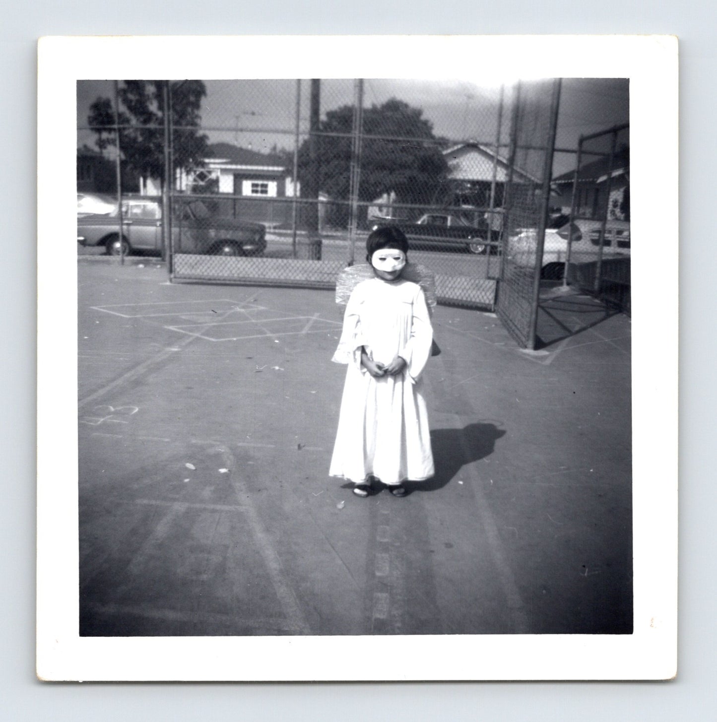 1969 Halloween child angel costume mask wings outdoor playground snapshot square photo