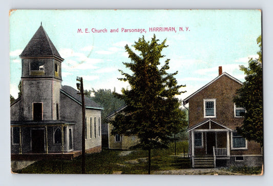 Hand-colored postcard showing Methodist Episcopal Church and parsonage in Harriman, New York, with towered church building and adjacent residence; divided back with 1914 postmark and stamp.