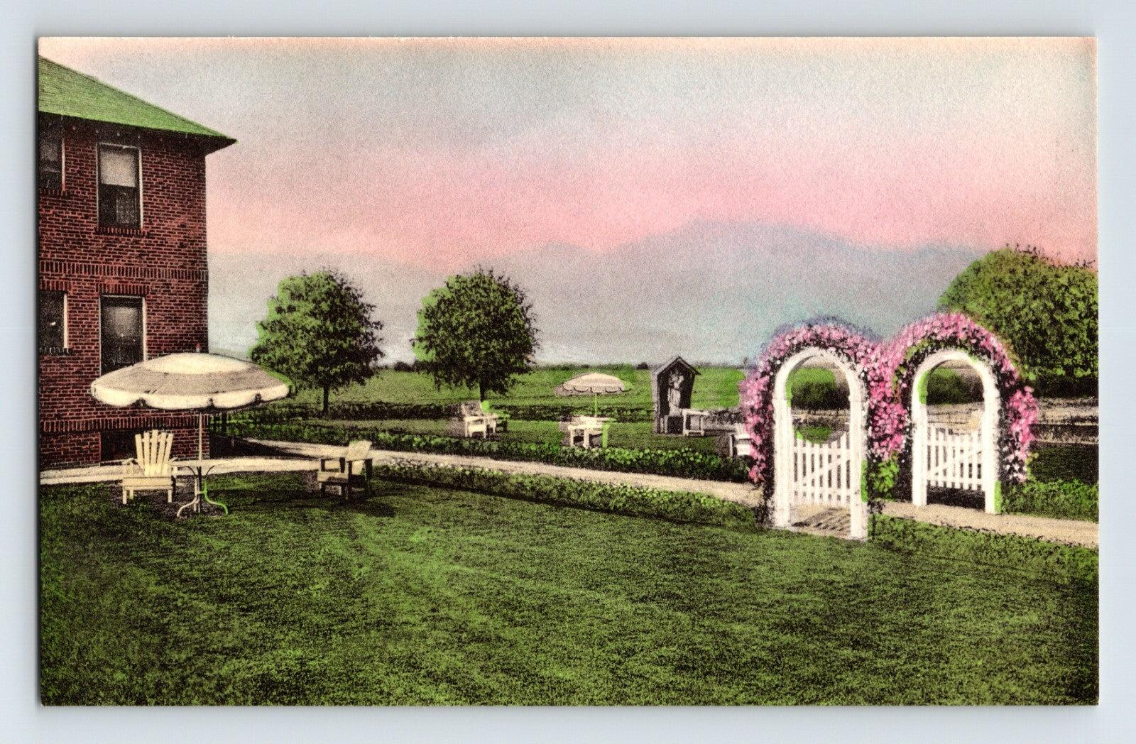 Hand-colored postcard of Lady Consolation Residence grounds in Amityville Long Island New York with garden arches and lawn seating