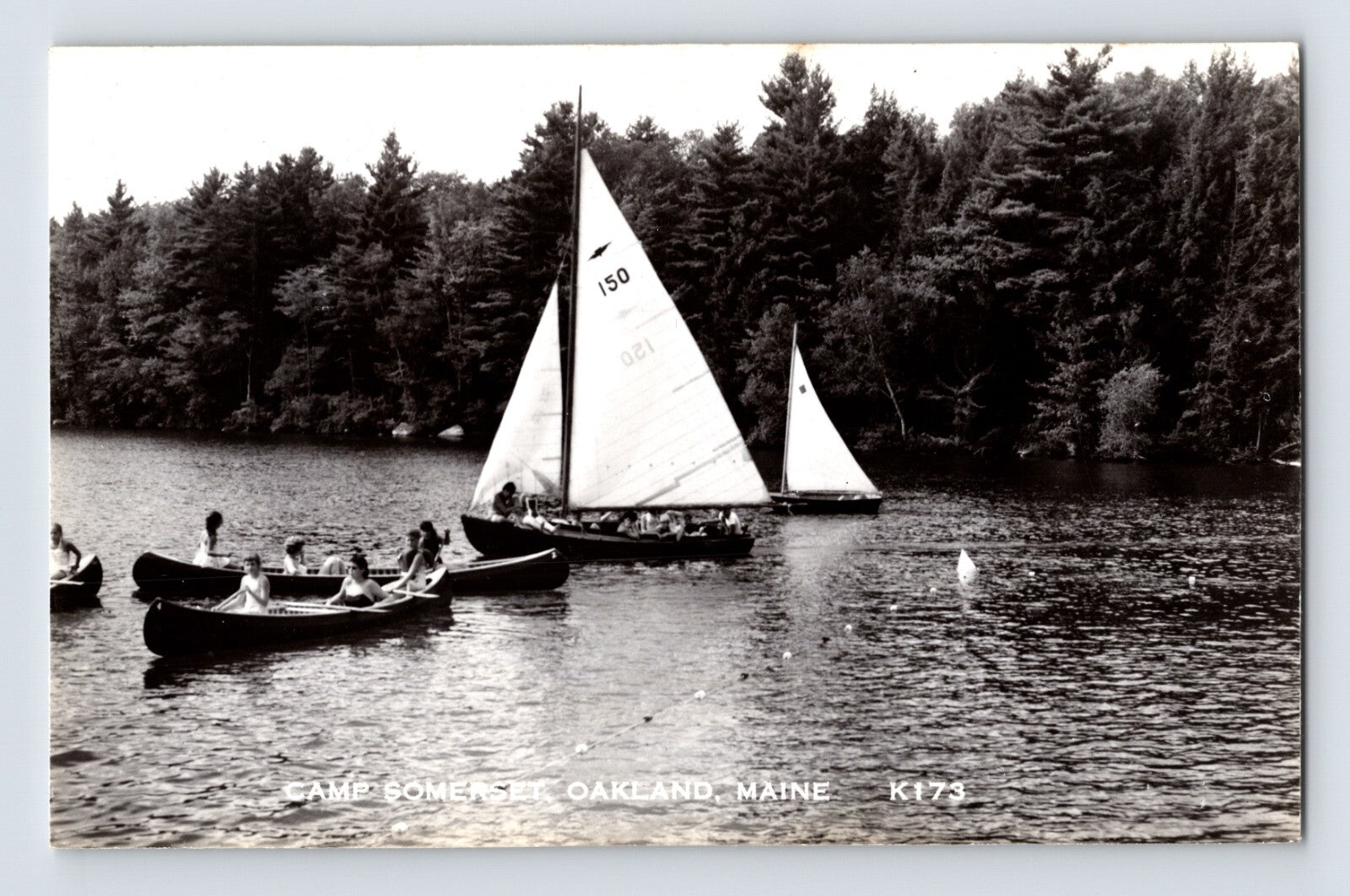 Camp Somerset Oakland Maine sailboats and canoes on lake with forest shoreline real photo postcard
