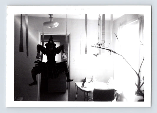 Halloween witch decoration hanging hallway streamers table party setup vintage home interior snapshot