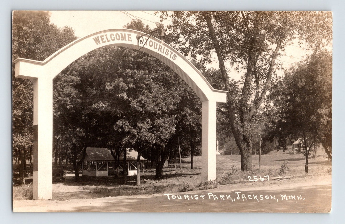 Jackson Minnesota tourist park entrance 1930s photo postcard with welcome arch trees and picnic shelter
