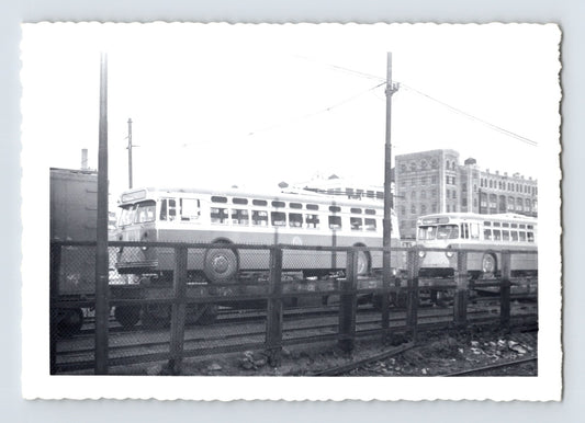 St Louis Car Company trackless trolley delivery at Bush Terminal Brooklyn with trolley coaches 3082 and 3087 on flatcars behind chain link fence