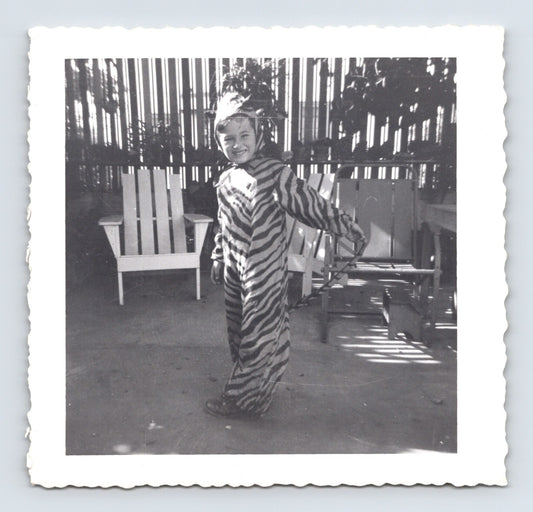 Child Halloween tiger costume striped outfit backyard patio chairs October 1950 snapshot